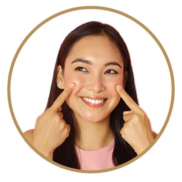 Smiling woman pointing at glowing cheeks